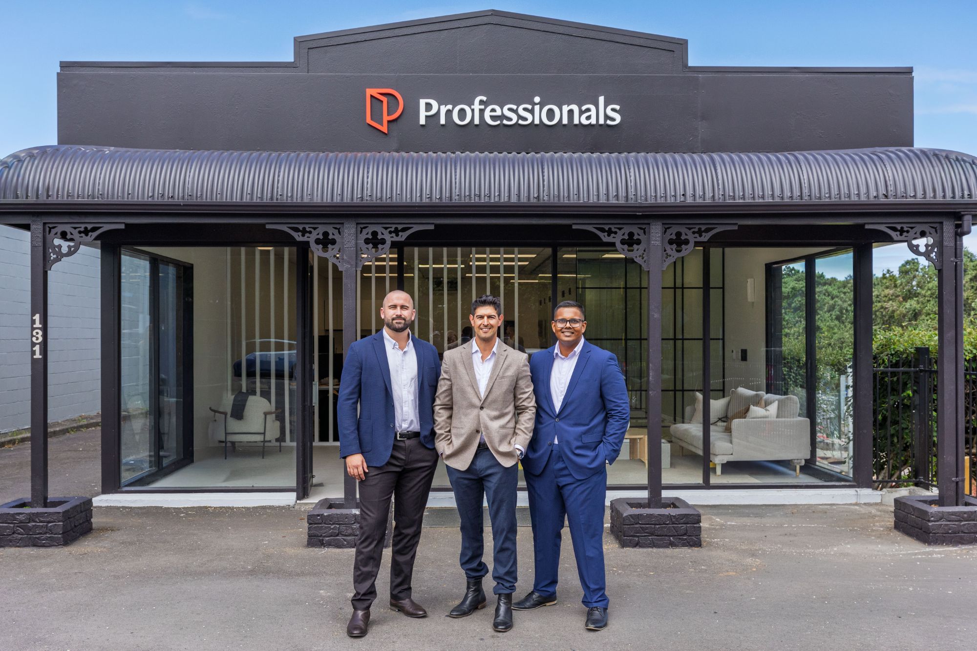 Derek and his team outside the Professionals shopfront