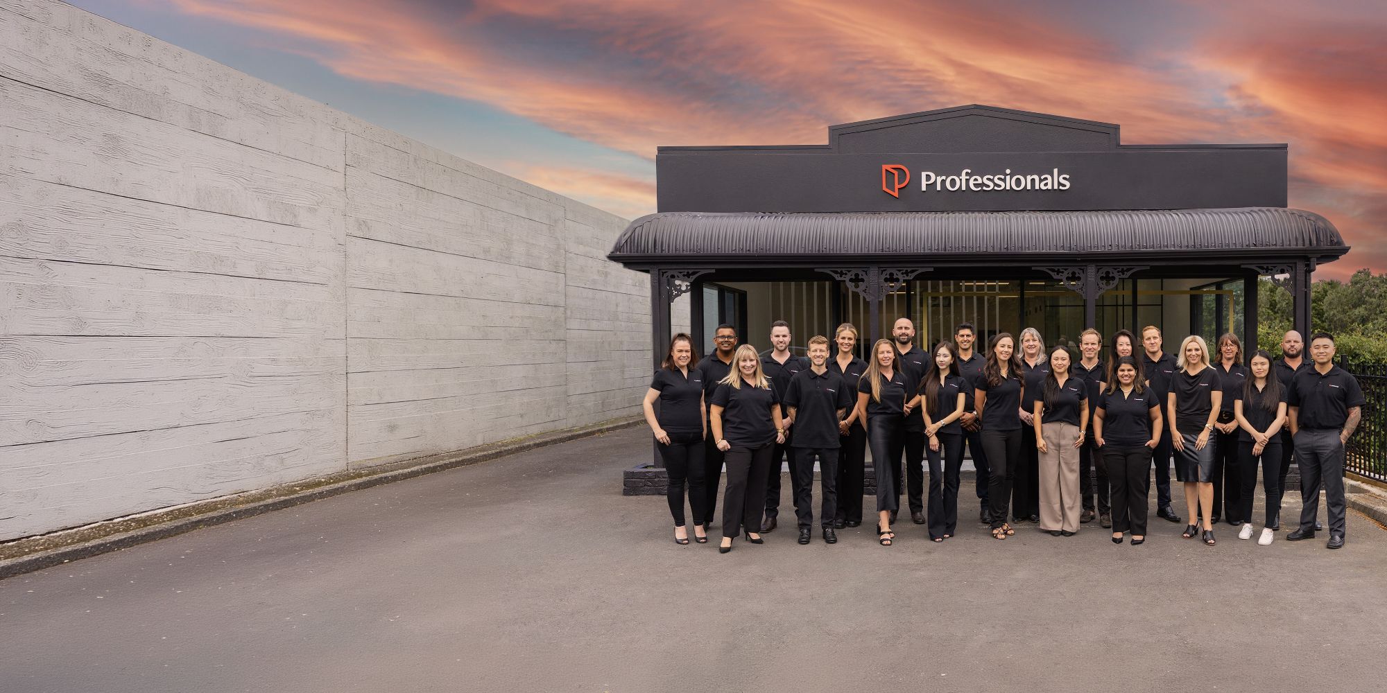 The Professionals team outside the shopfront at dusk