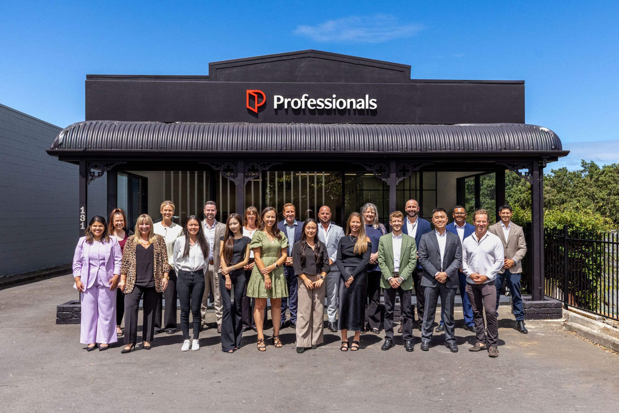 The Professionals team outside the shopfront at dusk