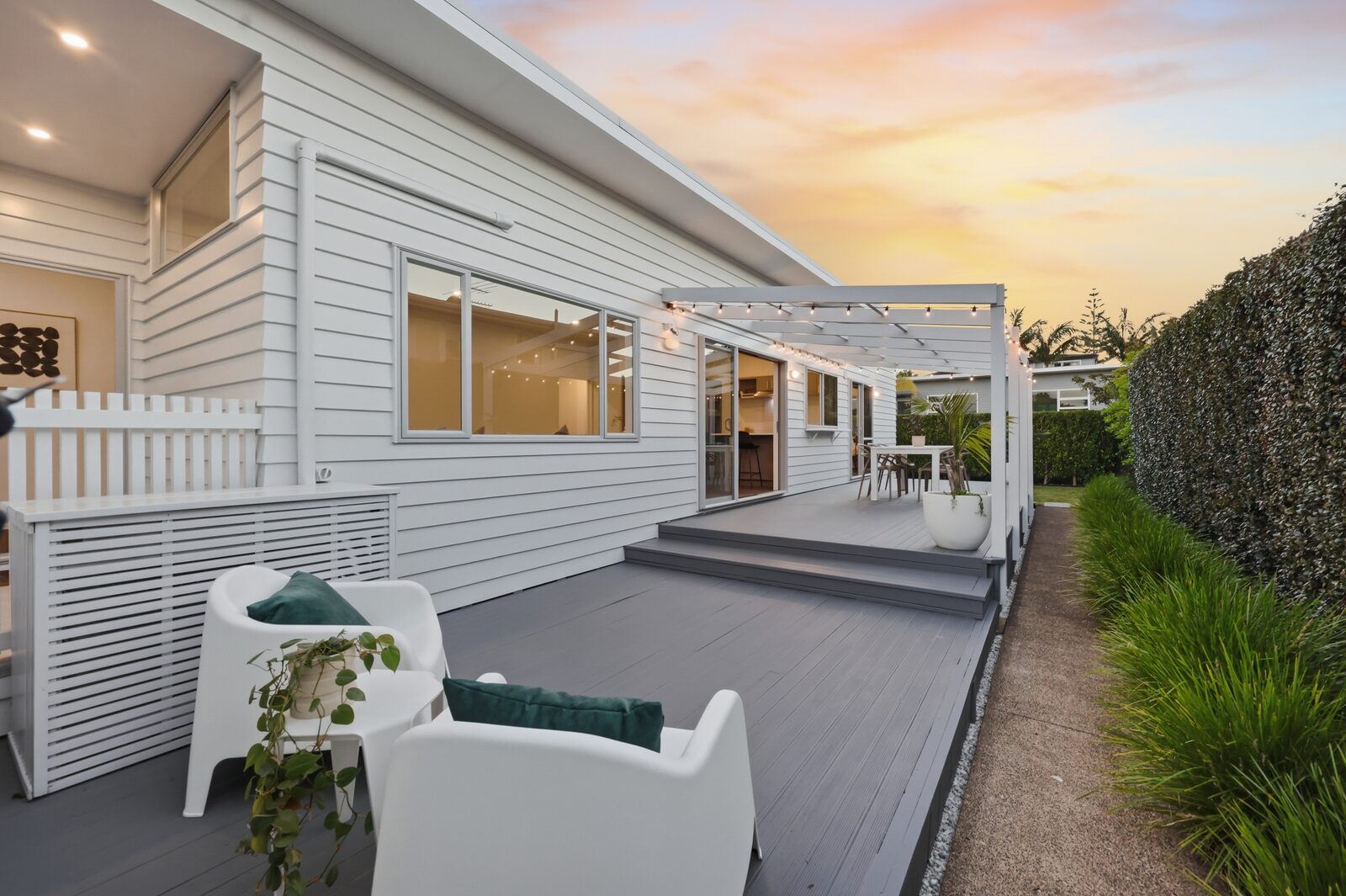 A well-kept Auckland home and landscaped deck at sunset -->
