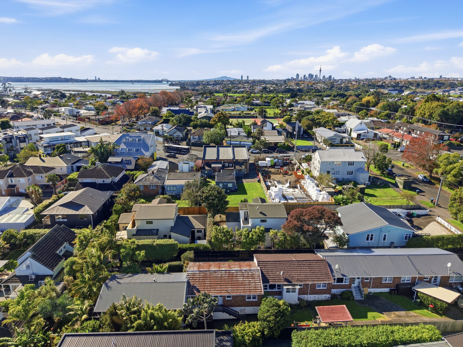 Aerial view of Auckland residential density and active development near the harbour -->