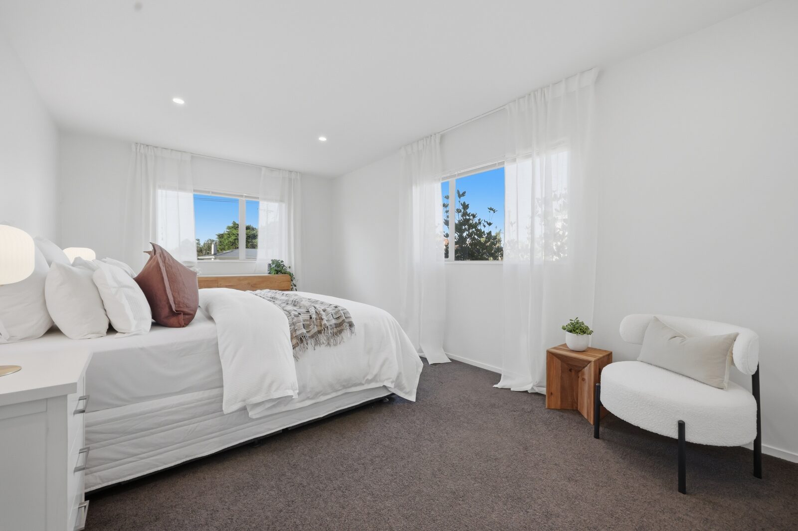 A bright, professionally presented bedroom in an Auckland home -->