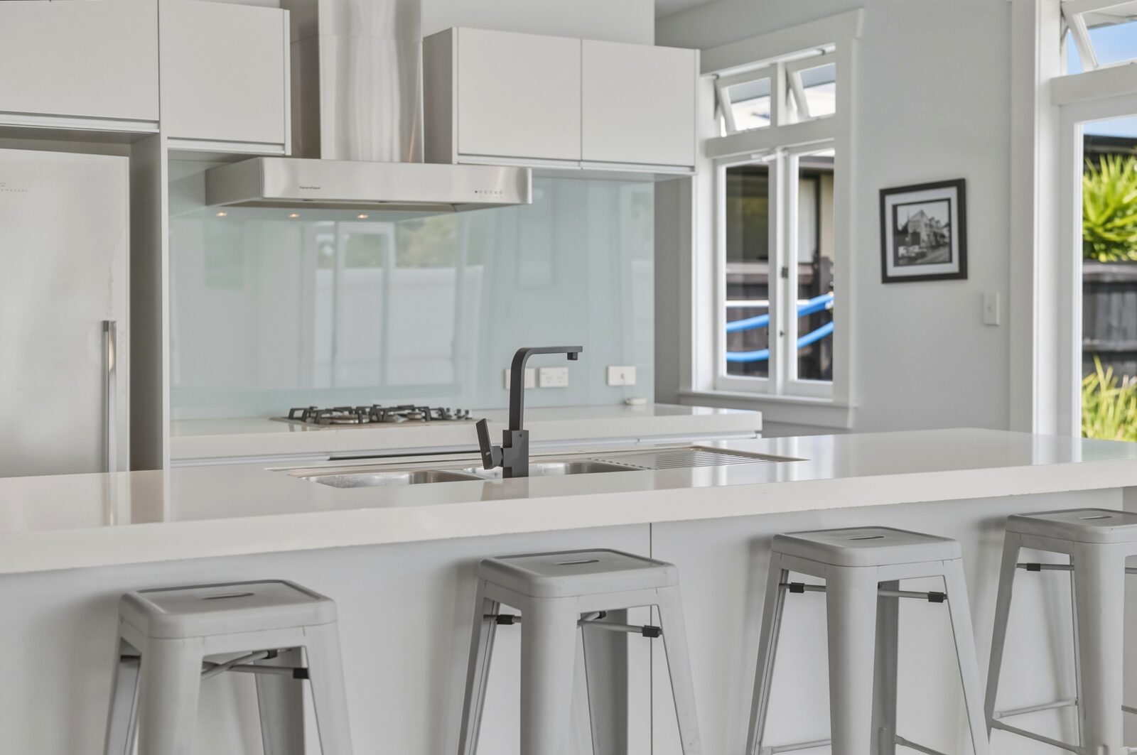 Bright staged kitchen with white cabinetry and a central island -->