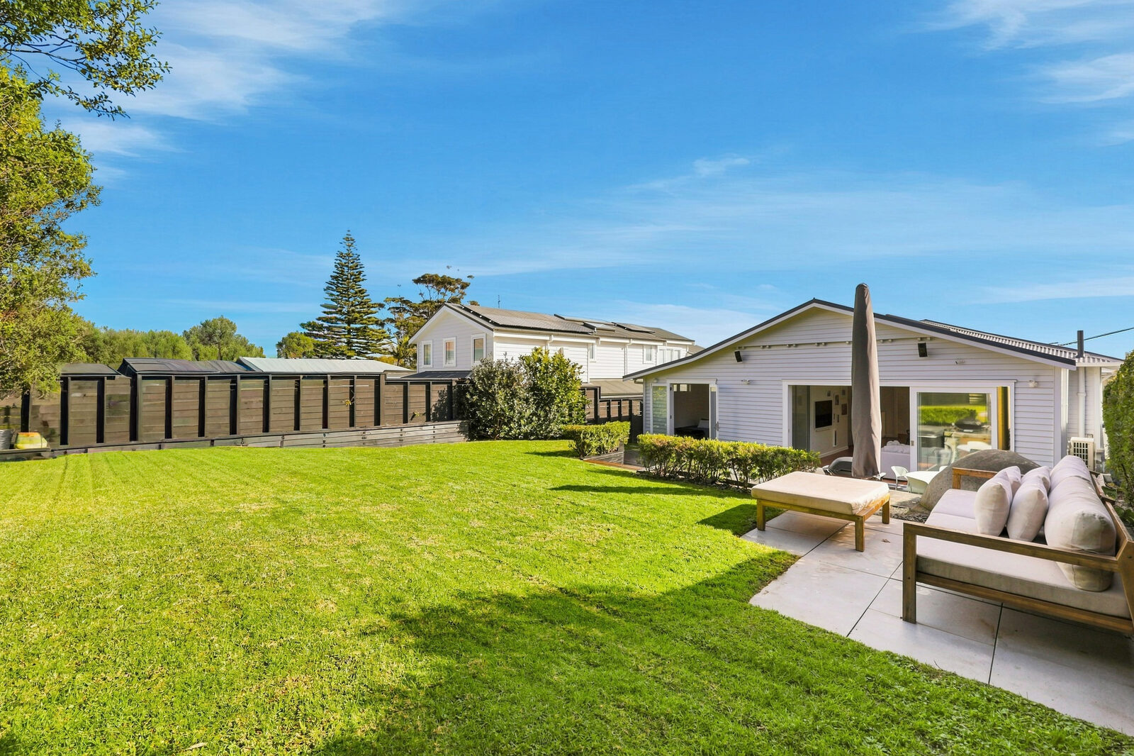 Well-maintained Auckland home with a landscaped lawn and garden -->